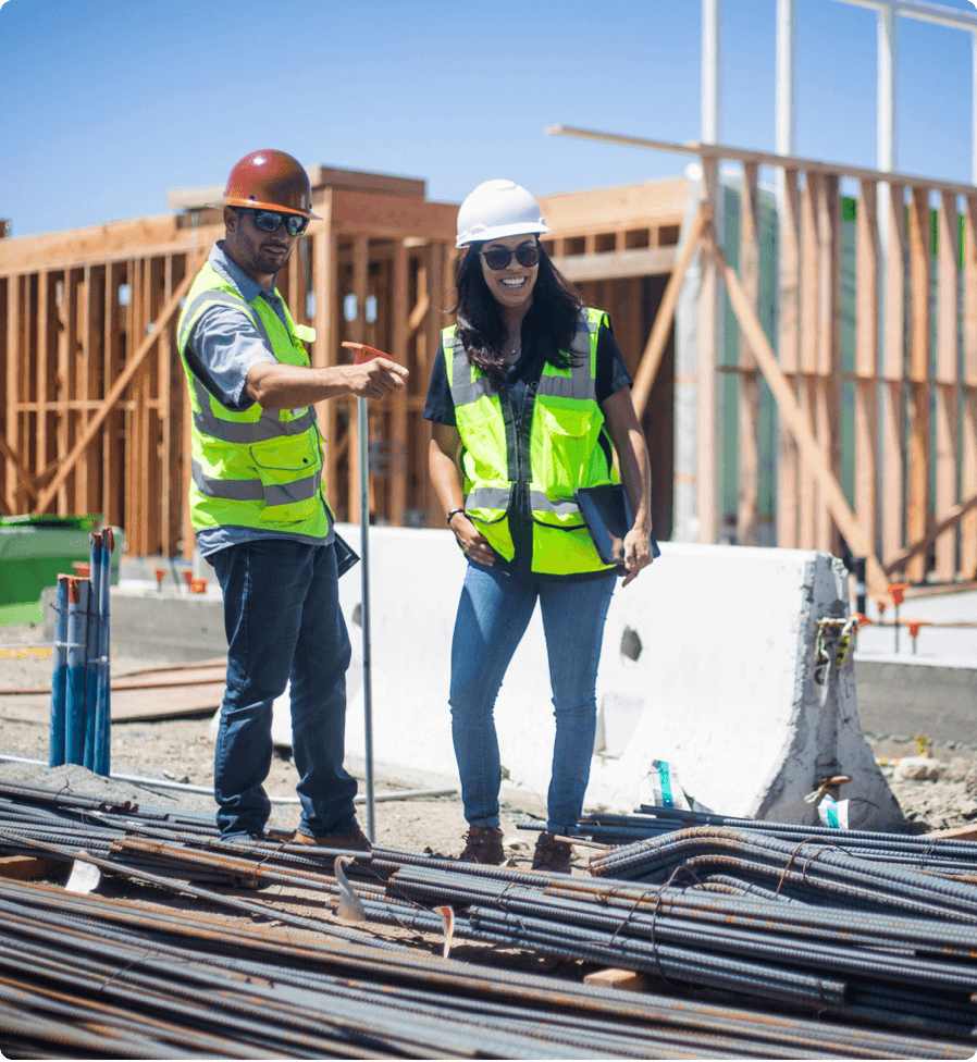 Two people on a construction site, making observations with the help of an inspection software